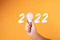 Hand holdign white lightbulb and 2022 text on yellow background-MVFlickr.jpg