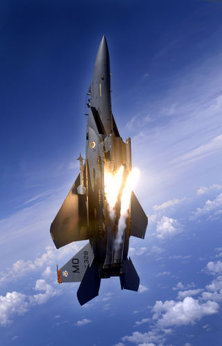 "An F-15E Strike Eagle from the 391st Expeditionary Fighter Squadron pops flares during an aerial training dog fight."